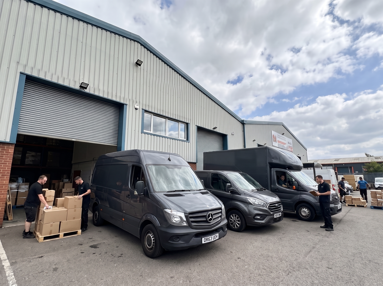 Deliveree team loading vans outside the depot for a commercial job