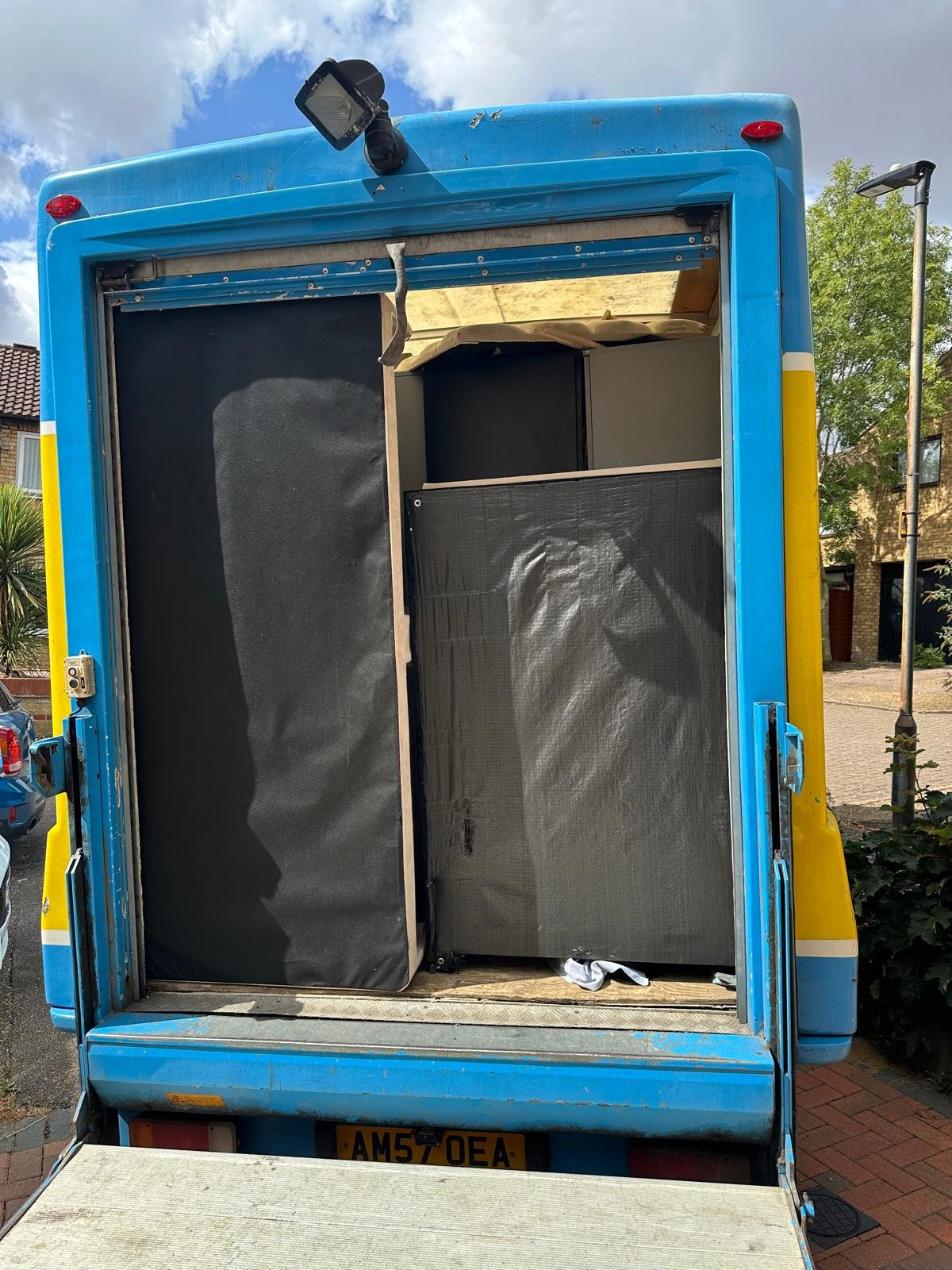 Van tail lift down with items wrapped and loaded for a commercial move